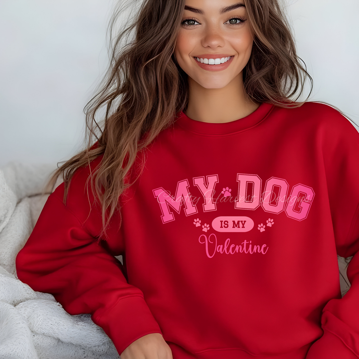 Model wearing a red sweatshirt featuring the ‘My Dog Is My Valentine’ design in pink varsity-style text with paw print accents.