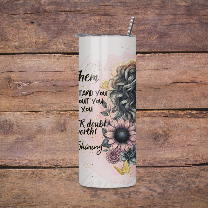 Rotating view of a 20oz skinny tumbler featuring the ‘Let Them’ Pink Floral Wrap design. The tumbler shows a stylish woman with wavy hair, a leopard-print headband, pink and gray flowers, and an inspirational quote about self-worth. The video highlights the full wrap design.